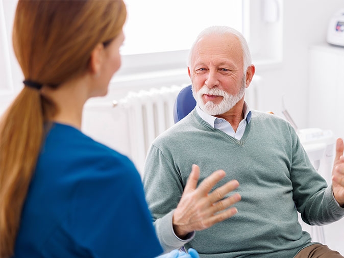 dentist and patient discuss sleep apnea treatment