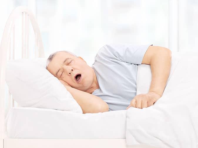 middle-aged man snoring due to sleep apnea