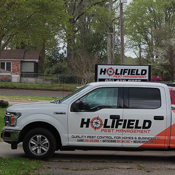 a holifield pest management company vehicle parked outside in laurel mississippi