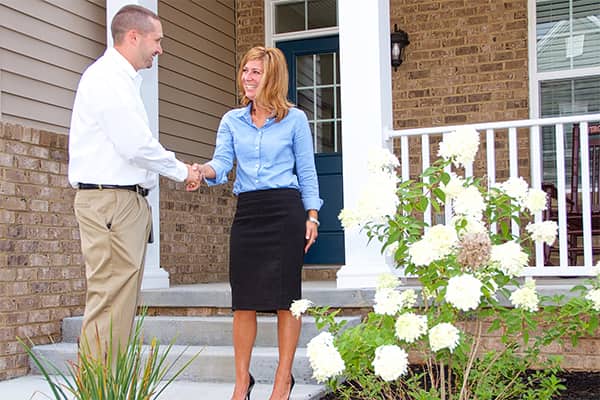 a service technician shaking hands with a homeowner outide a salem virginia home