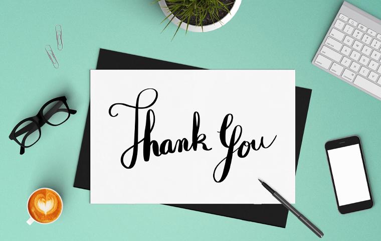 a thank you note on a desk