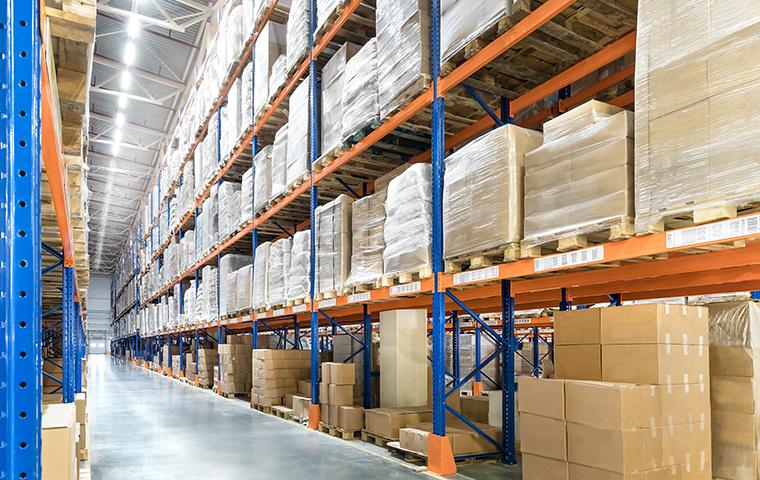 We Stop Pests From Contaminating Stored Goods interior of a warehouse with stocked shelves in valencia california
