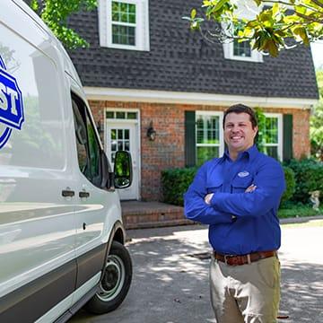 Find Out Why JPS Is The Best! a jury pest services technician standing outside of a home in richmond county georgia