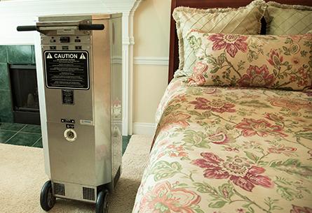Learn More About Our Comprehensive Bed Bug Treatments a bed bug heater in a bedroom