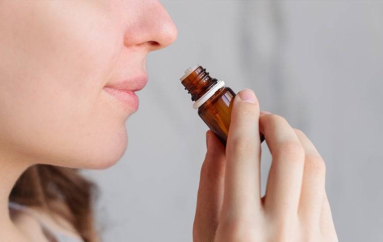 woman sniffing essential oil