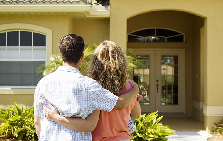 happy couple outside home