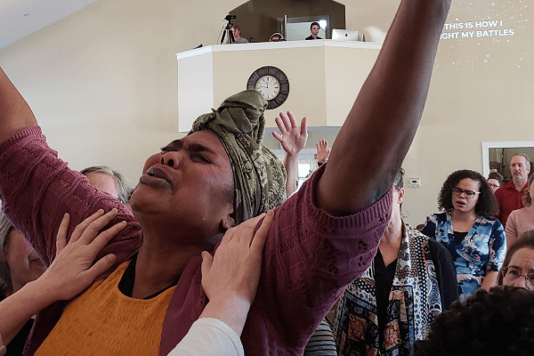 woman lifting hands in worship