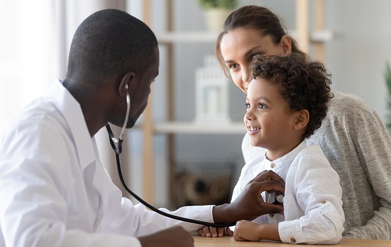 a doctor checking the heartbeat of his patient