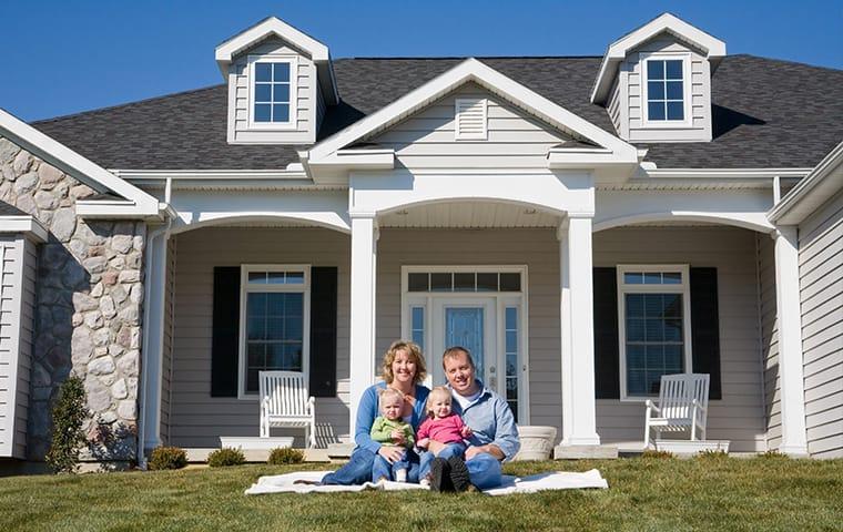 We Offer Year-Round Home Protection From Pests a family sitting outside their home in frisco texas
