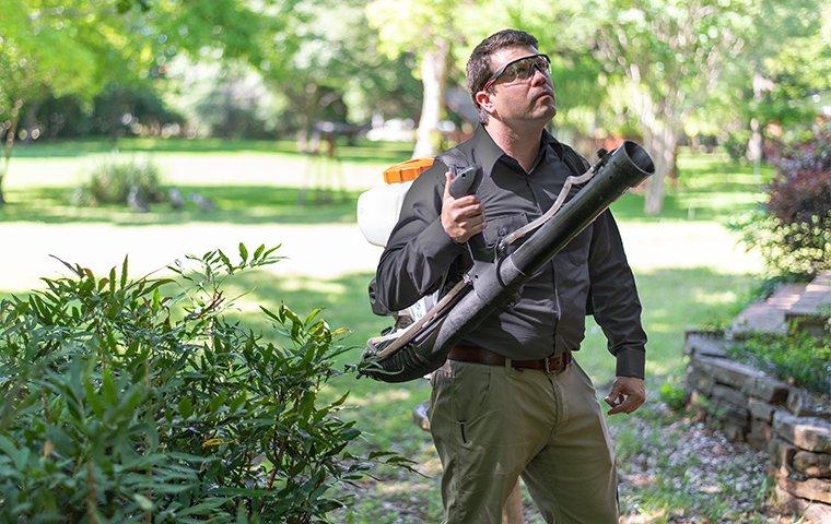 a mosquito expert treating the exterior of a home in hendersonville north carolina