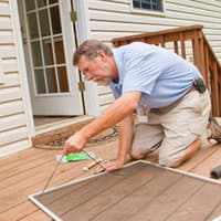 Early Fall Pest Prevention Protects Your Home From Overwintering Pest Homeowner repairing screen