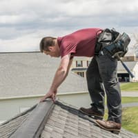 Keep Pests Out Of Your Albany Home This Spring pest control technician fixing roof