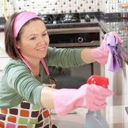 Tips To Avoid Pest Problems This Spring woman cleaning her kitchen