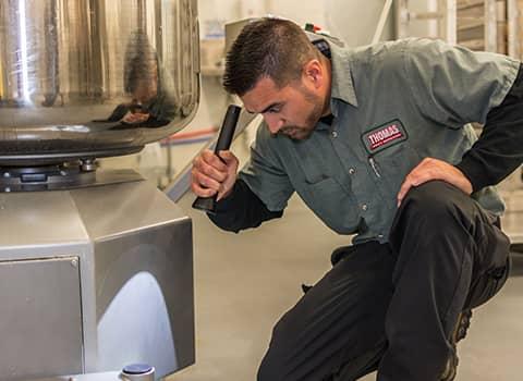 Protect Your Halfmoon NY Business With Thomas Pest Services technician inspecting halfmoon commercial facility
