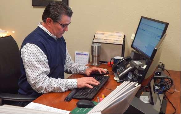 a pest control staff member typing on a computer