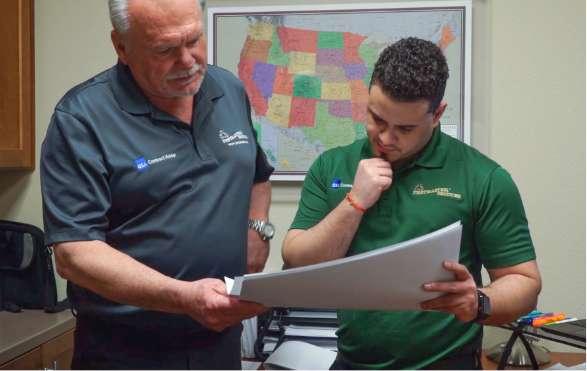 two pest control experts discussing a plan