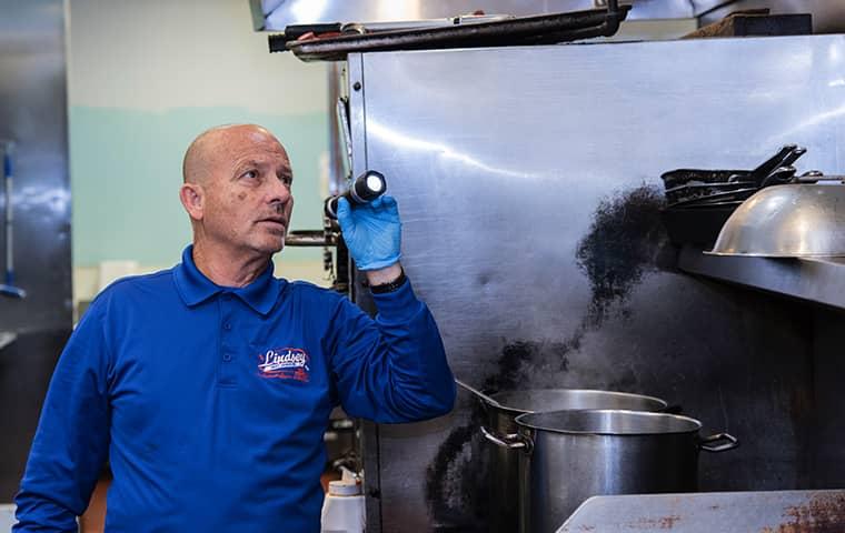 a technician inspecting a saint augustine florida commercial kitchen