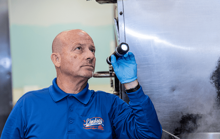 a pest technician inspecting a commercial building in jacksonville florida