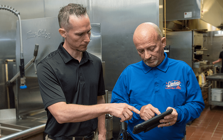 a pest technician talking with a local business owner in yulee florida