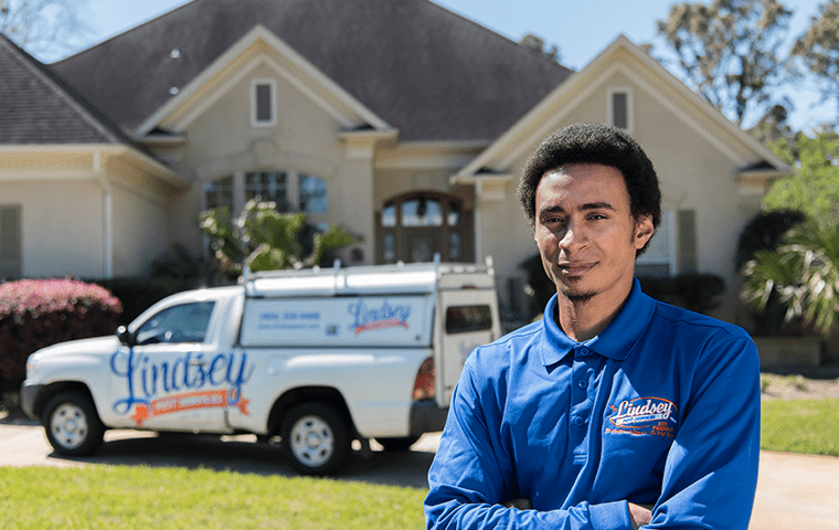 a pest technician standing outside of a ponte vedra beach florida home