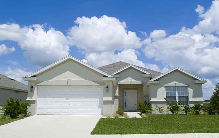 a white one story house with attached garage