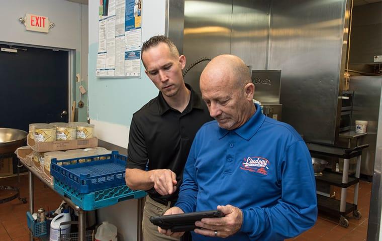 a lindsey technician meeting with a client in a st augustine beachflorida commercial kitchen