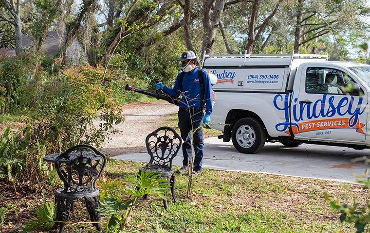 a technician spraying for mosquitoes in vilano beach florida