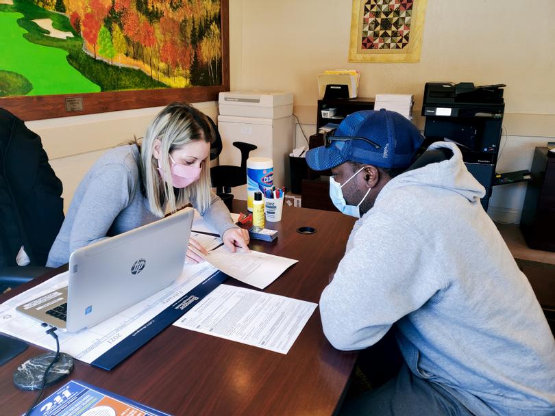 Volunteer Tax Preparer assists Marlon Service with his taxes