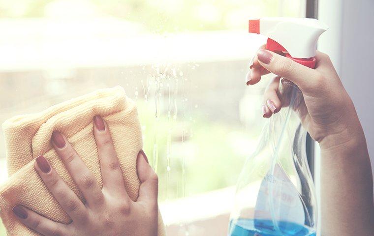 a woman washing a window