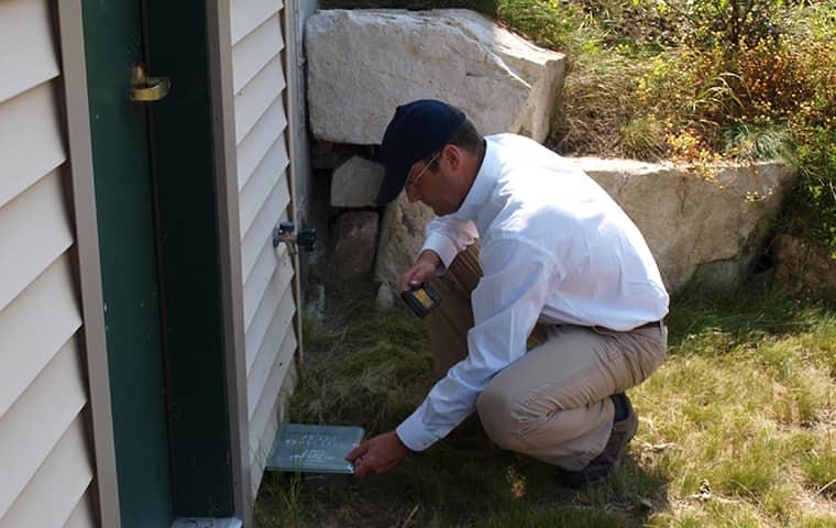 technician performing a rodent inspection
