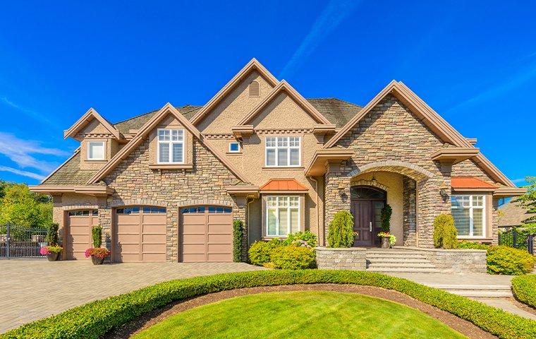 a large brick three story house