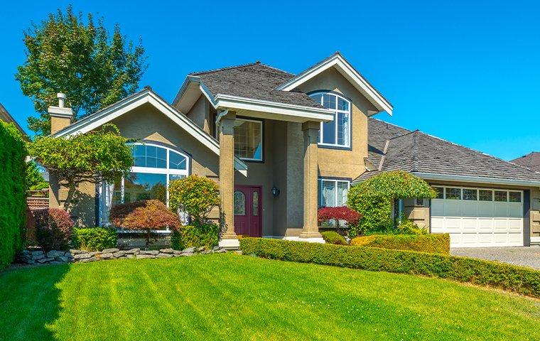 a beige two story house