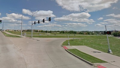 Use the pedestrian signals and walkways to navigate this path as it crosses I-74 interchange ramps
