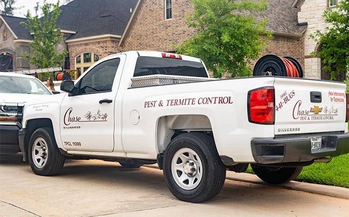 Our Follow Up Services Make Sure Pests Are Gone company truck parked at house