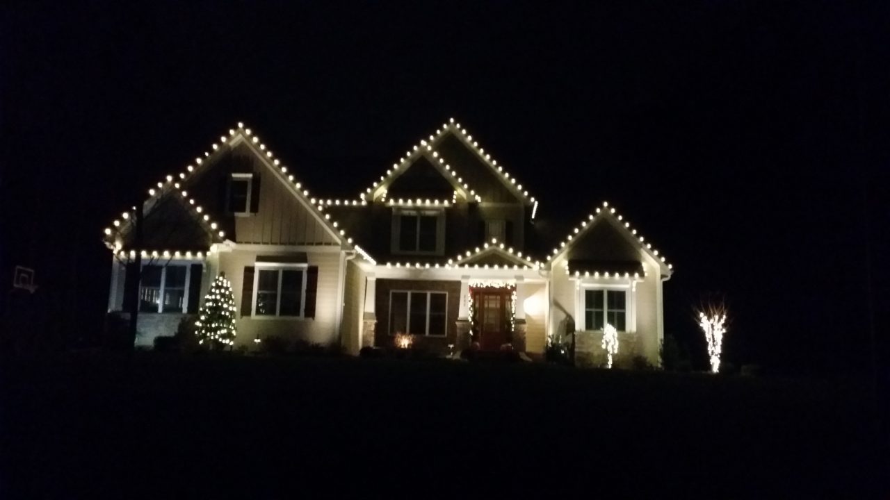 a home with christmas lights at night