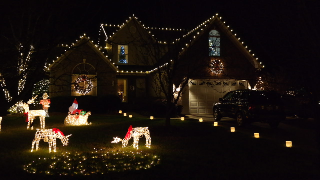 a house and lawn ornaments with christmas lights