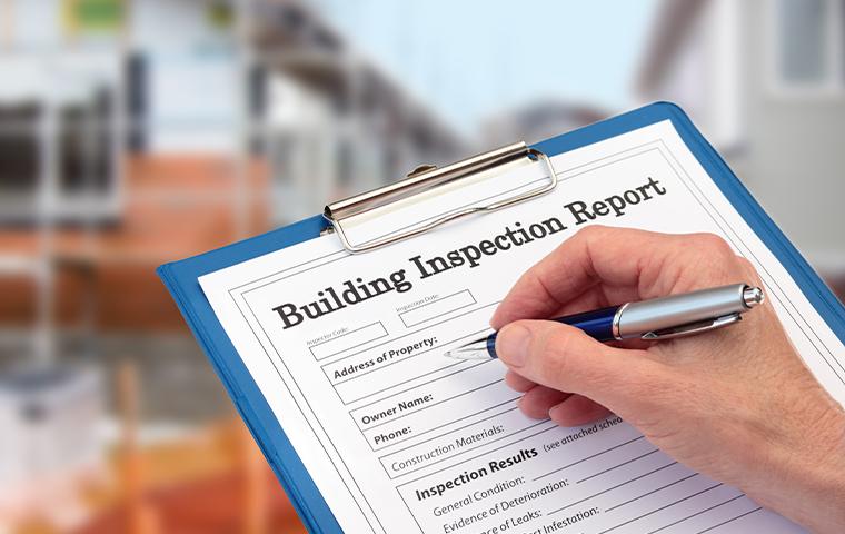 building inspection report on clipboard