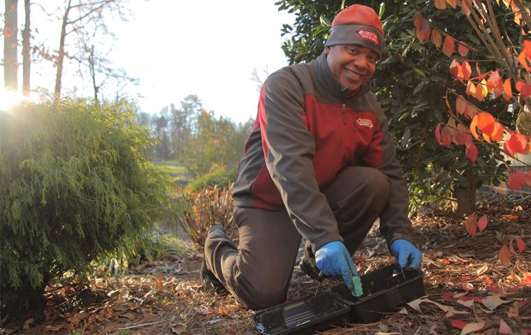 go forth technician kneeling over bait box