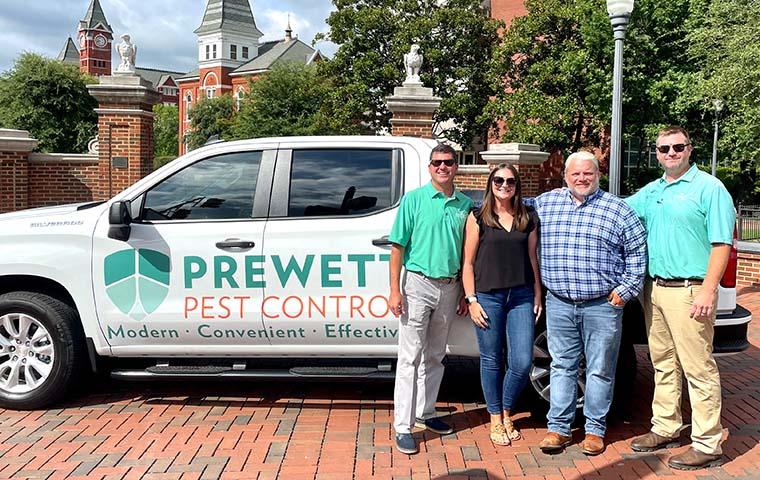 4 of Prewett's staff standing in front of Prewett branded truck