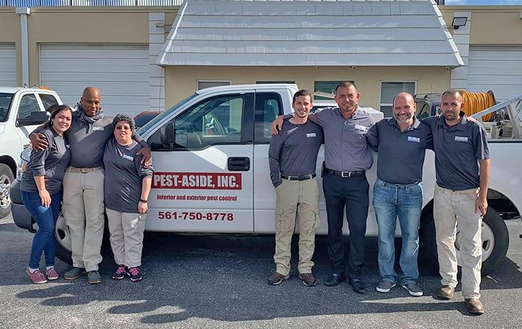 Our Expert Technicians Are Friendly & Professional the staff of aaa riteway and pest aside standing in front of a company vehicle in pompano beach florida