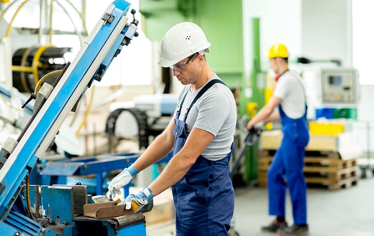workers using equipment in a manufacturing facility in boca raton florida
