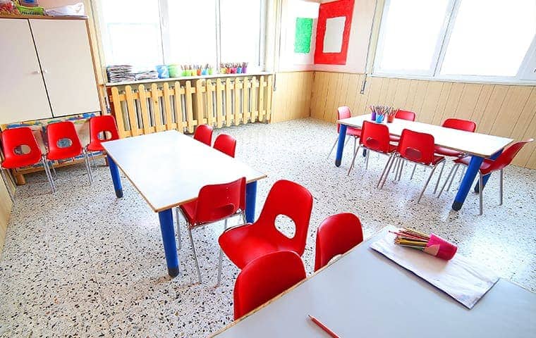 a school classroom with red chairs around a few tables in rocklin california