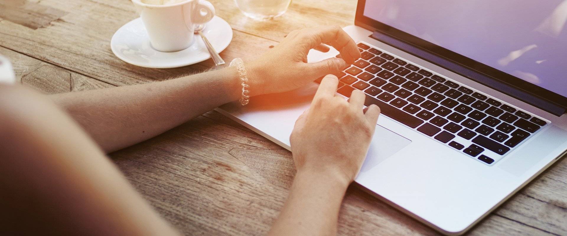a woman typing on a laptop