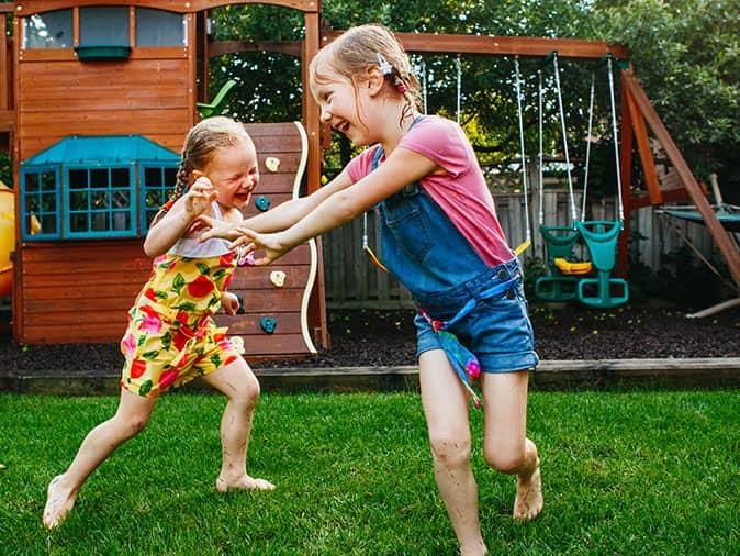 sisters playing in backyard in colorado
