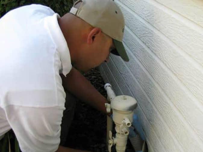 pest control tech performing exclusion work to prevent pests from getting inside a colorado springs home