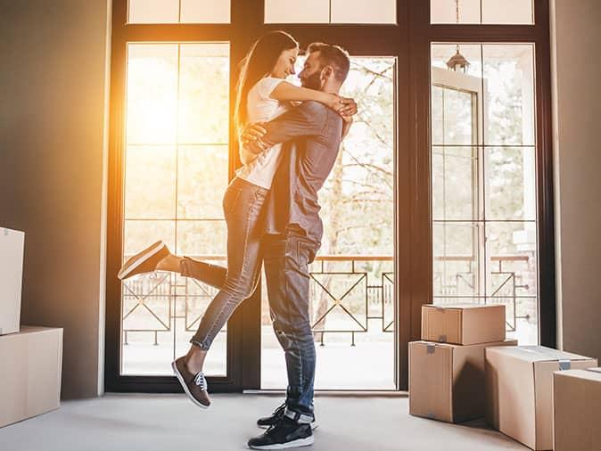 Signs Of Pest Activity To Watch For When Looking At New Homes new homeowners hugging in their denver home
