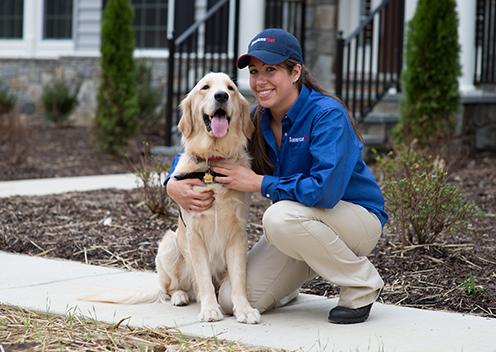 a service technician smiling with a k9 inspection dog in falls church virginia