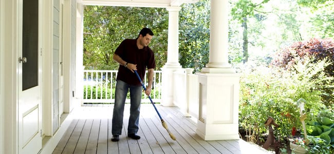homeowner sweeping his maryland porch