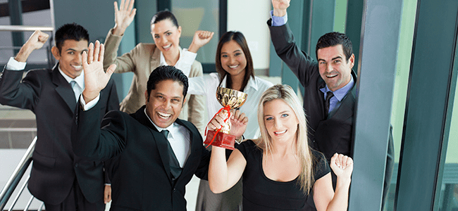 employees raising a trophy