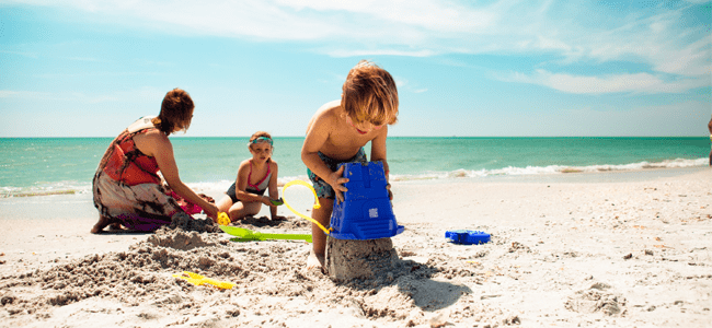 family playing at beach